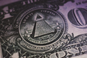 Close up of a dollar bill focusing on the all seeing eye