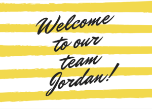 White and yellow striped sign welcoming Jordan to the team