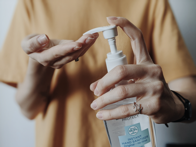 A women using hand sanitizer